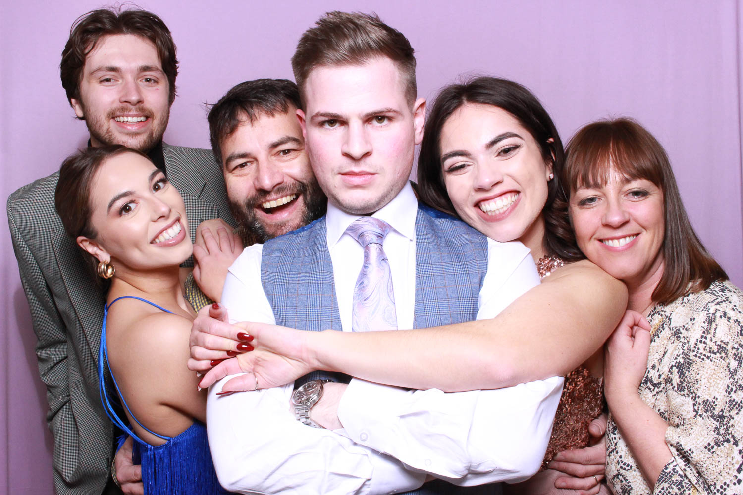 Group in modern classic photo booth with pink backdrop at wood hall weddings