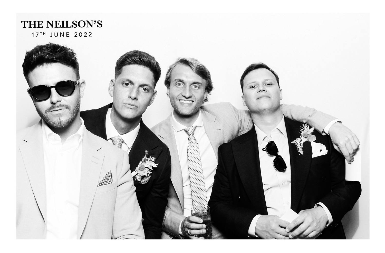 Groom and group of friends in black and white photo at a wedding
