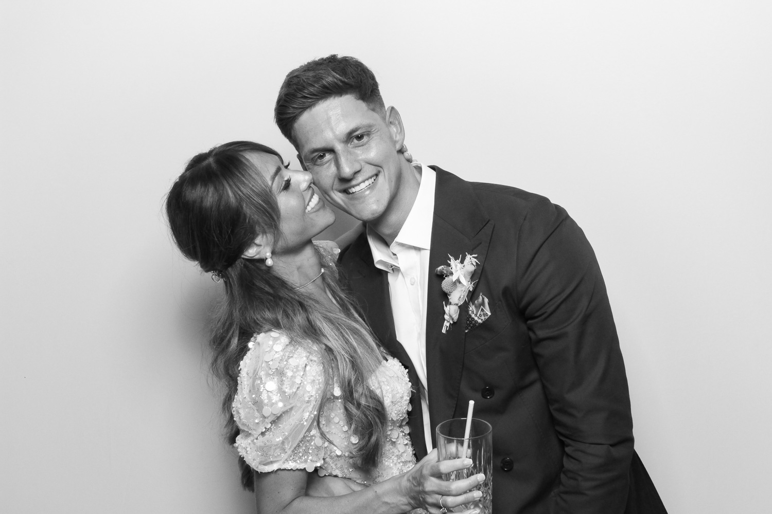 Bride and Groom together smiling in black and white photo booth at a wedding