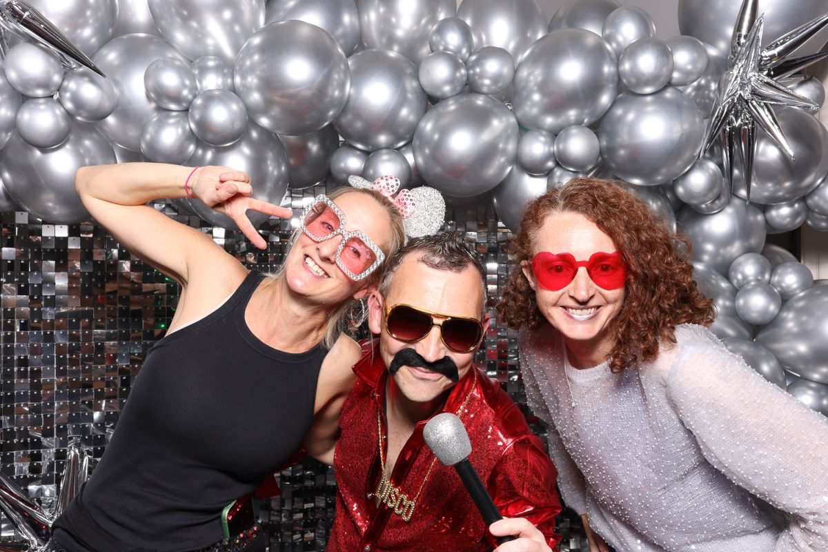 GROUP OF GUESTS IN ICON PHOTO BOOTH AT STAFF PARTY AT SALTMARSHE HALL
